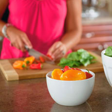 Woman chopping vegetables in a kitchen