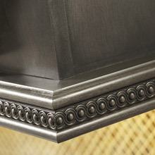 dark brown decorative insert moulding around base of wall cabinet or wood hood