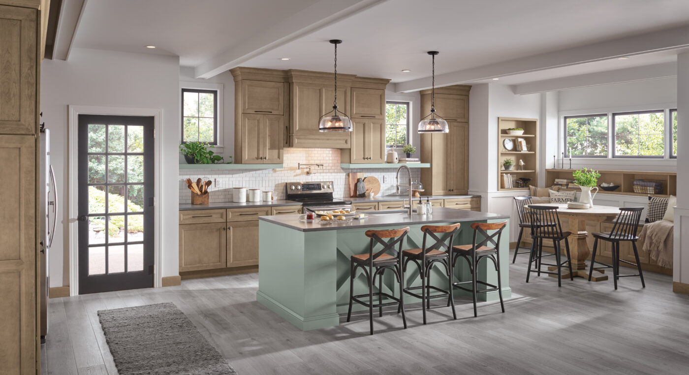 Mid-tone stained cabinetry with a mix of muted green on the island.