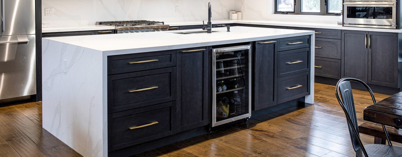 Charcoal stain cabinet finish on a kitchen island that incorporates a beverage center.