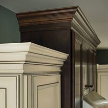 stacked crown moulding on off white and dark stained cabinets