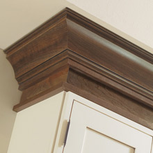 off white cabinets with contrasting dark brown stained cabinet moulding